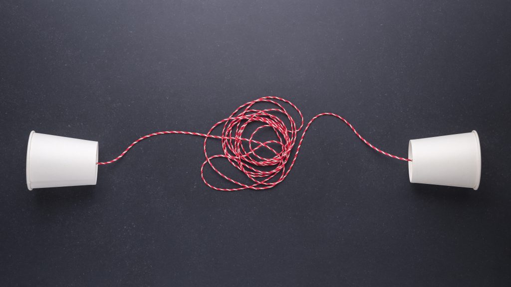 Two white paper cup connect with red rope used - Condor Concierge